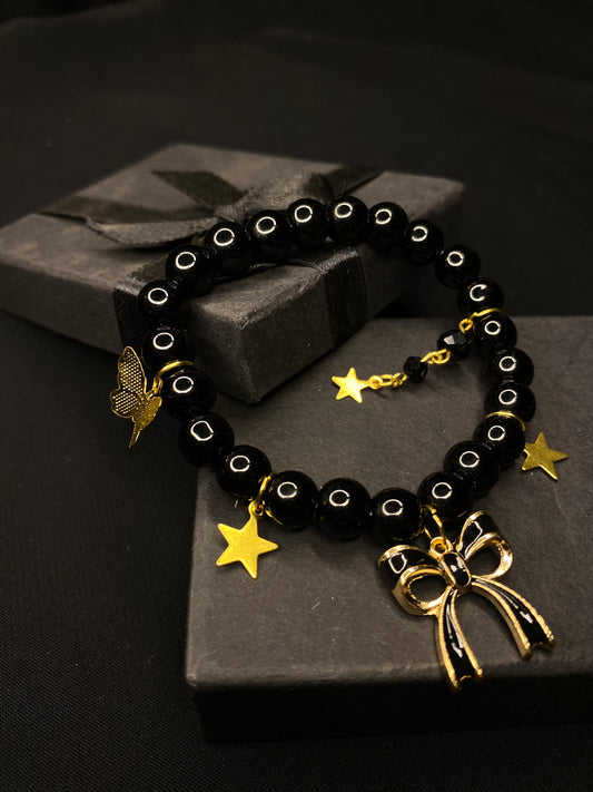 BRBST-01- Black stones Bracelet with hanging Charma( Bow, Butterfly, Star)